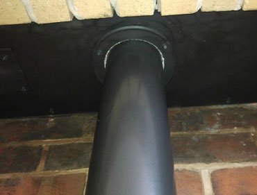 Flexible stainless steel chimney liner being fitted